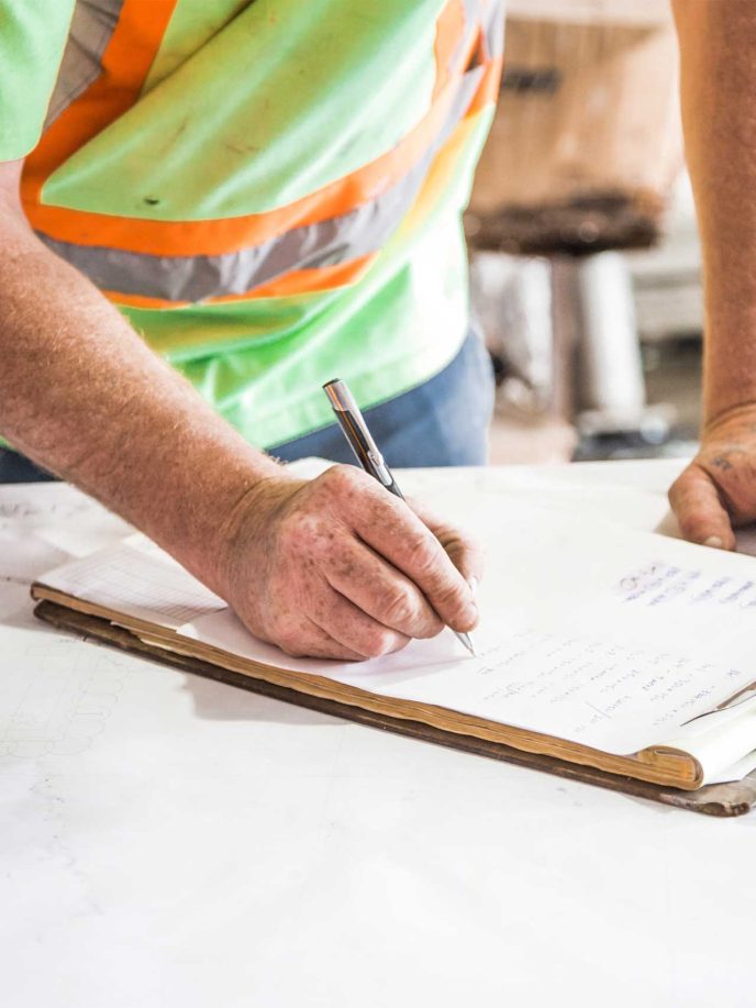Builder making notes on a clipboard - Retrofit West