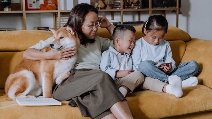Mum and two children sitting with their Shiba Inu on the sofa - Retrofit West
