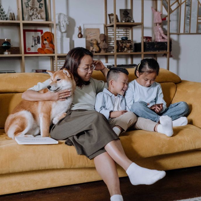 Mum and two children sitting with their Shiba Inu on the sofa - Retrofit West