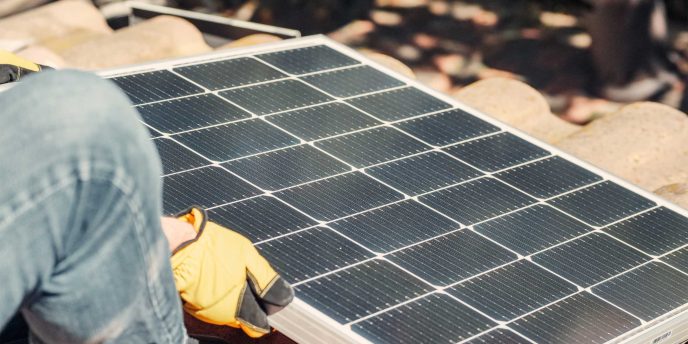 Solar panel's getting installed on the roof of a house - Retrofit West