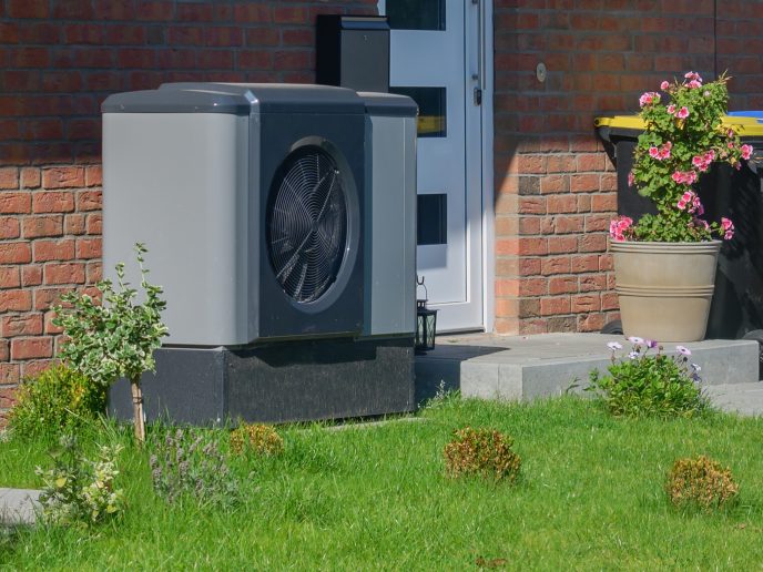 Air heat pump installed outside a front door