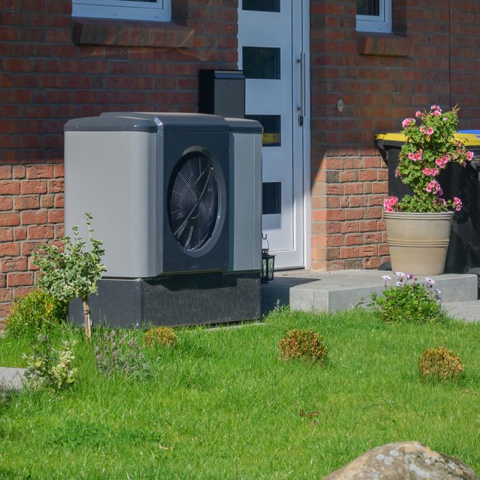 Air heat pump installed outside a front door