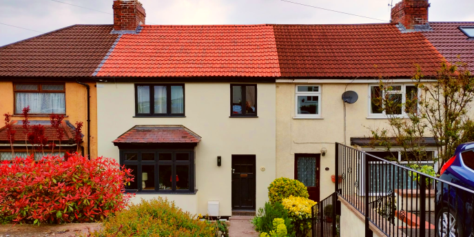 Row of terraced houses, the house in the centre of the image has had external wall insulation added.