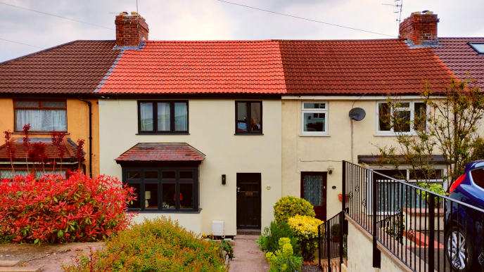 Row of terraced houses, the house in the centre of the image has had external wall insulation added.