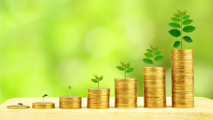 stacks of coins with plants growing from the tops