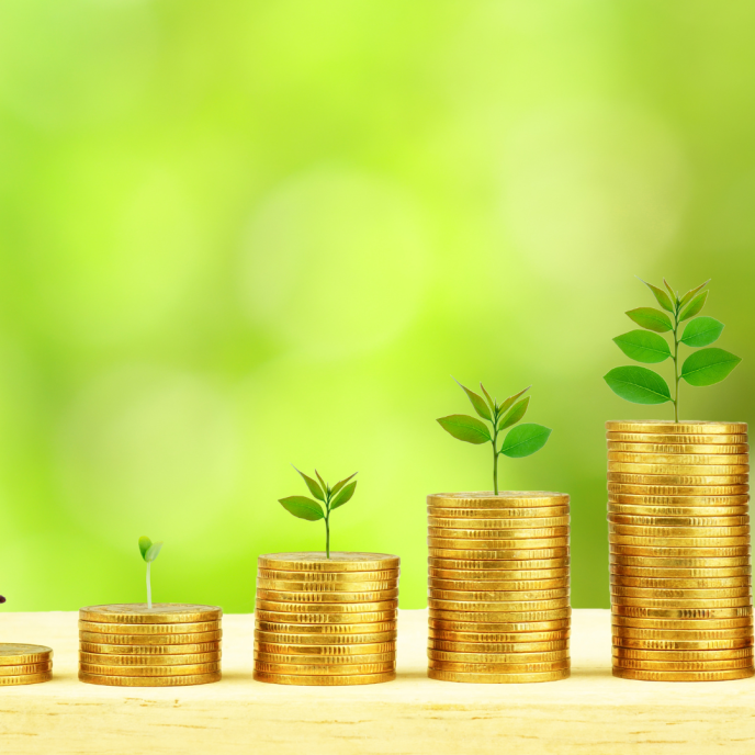 stacks of coins with plants growing from the tops
