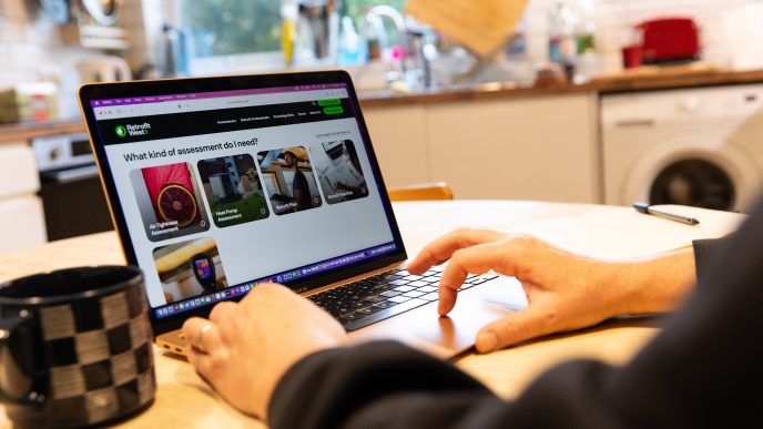 Using the Retrofit West website at home in Bristol to look up energy efficiency assessments. November 2024.