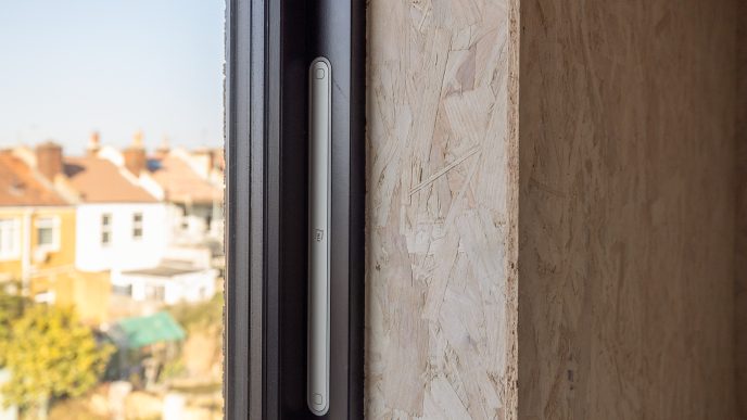 woodchip wall and grey window with triple glazing.
