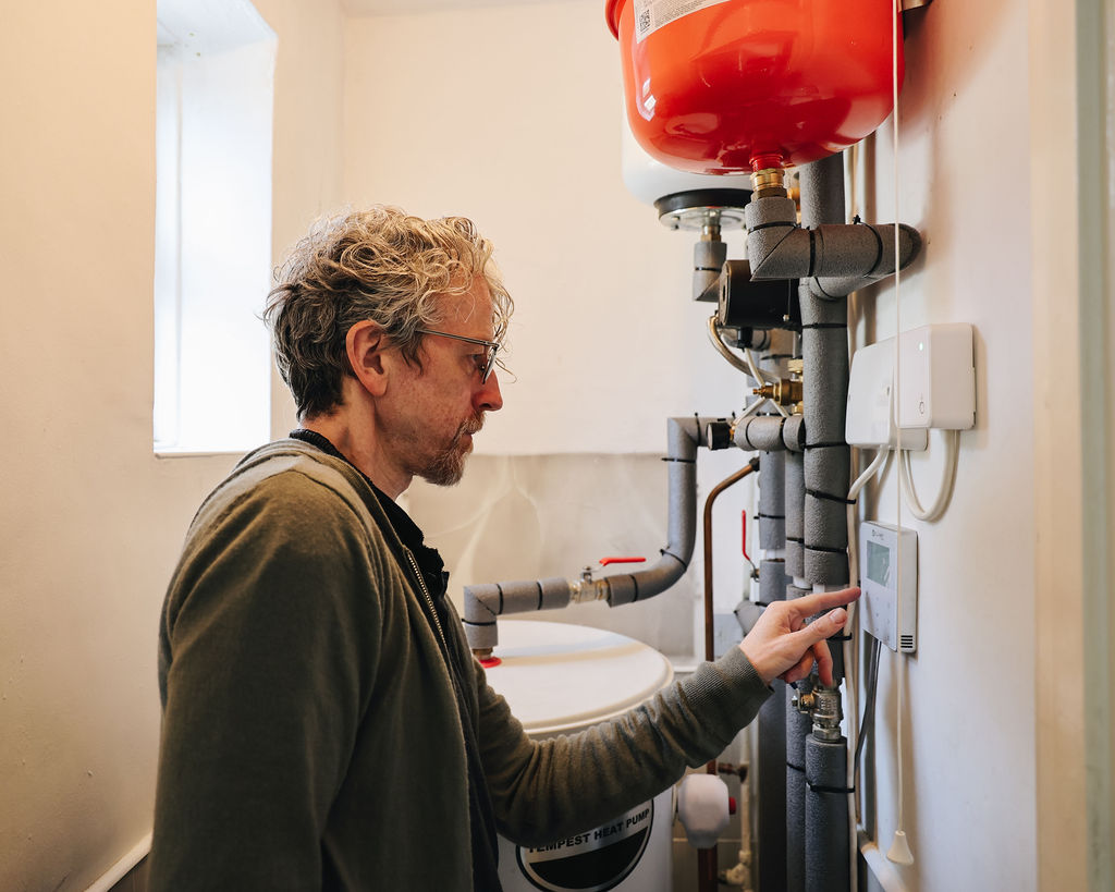 Kirk interacting with the control panel by his hot water tank