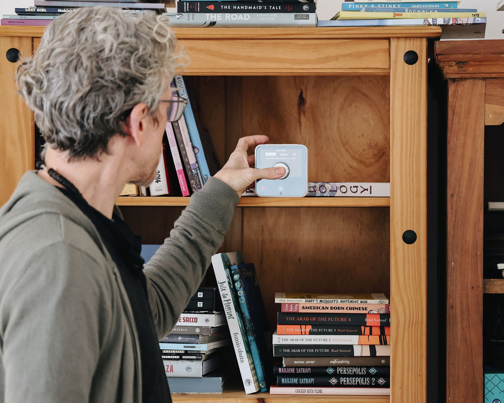 kirk interacting with his smart heating controls inside his home