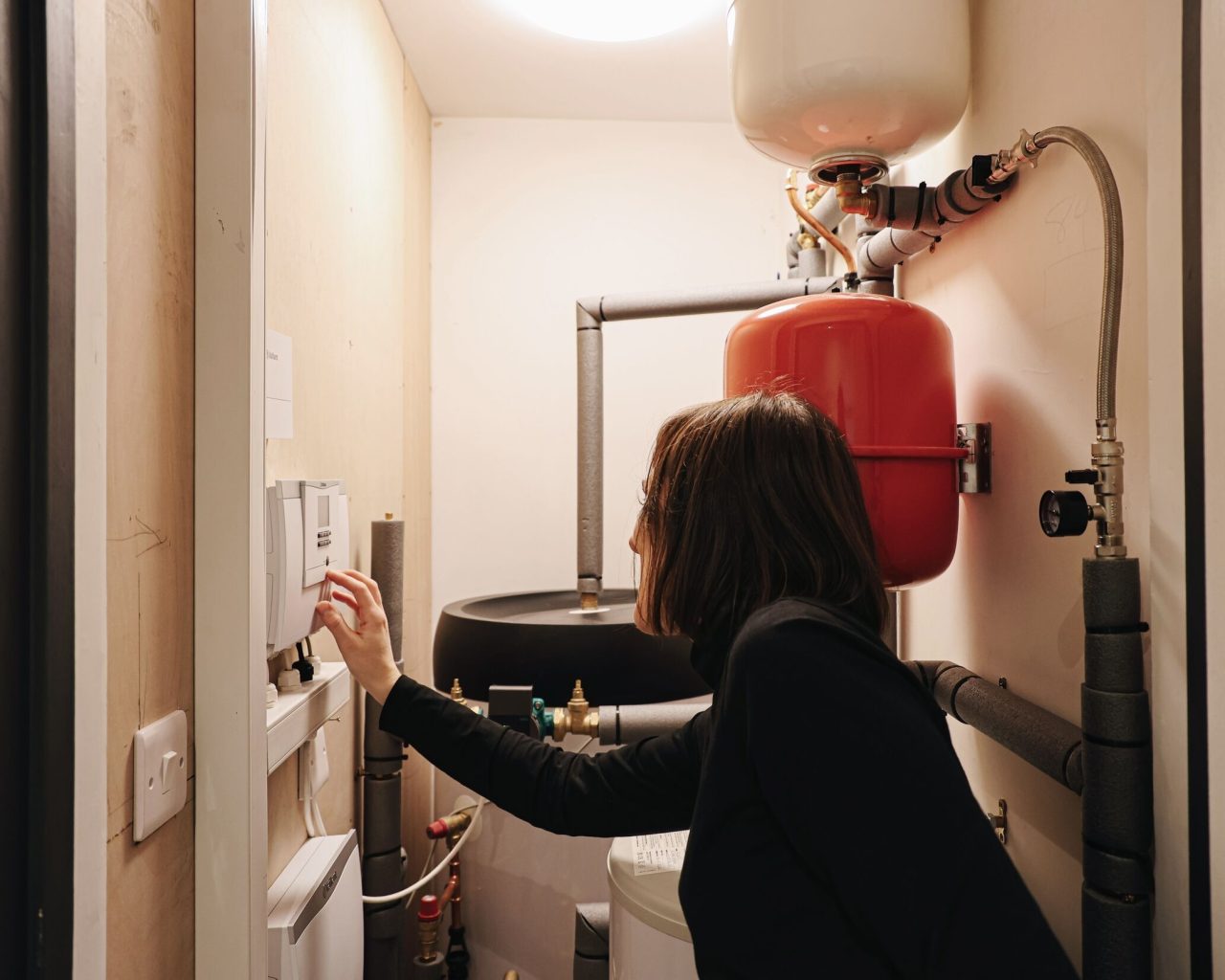 A homeowner looking at their heat pump settings