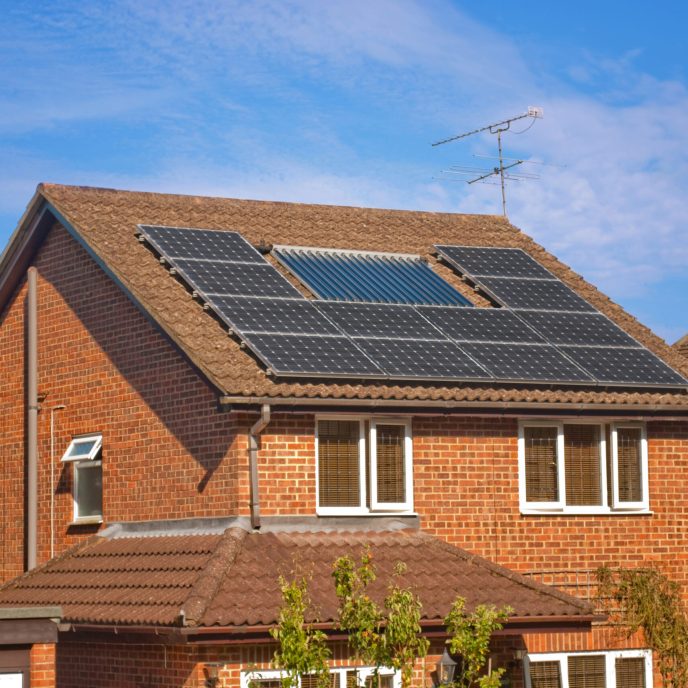 house with solar water heating panels on the roof