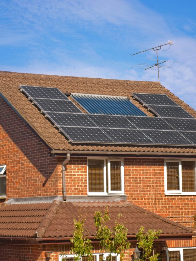 house with solar water heating panels on the roof