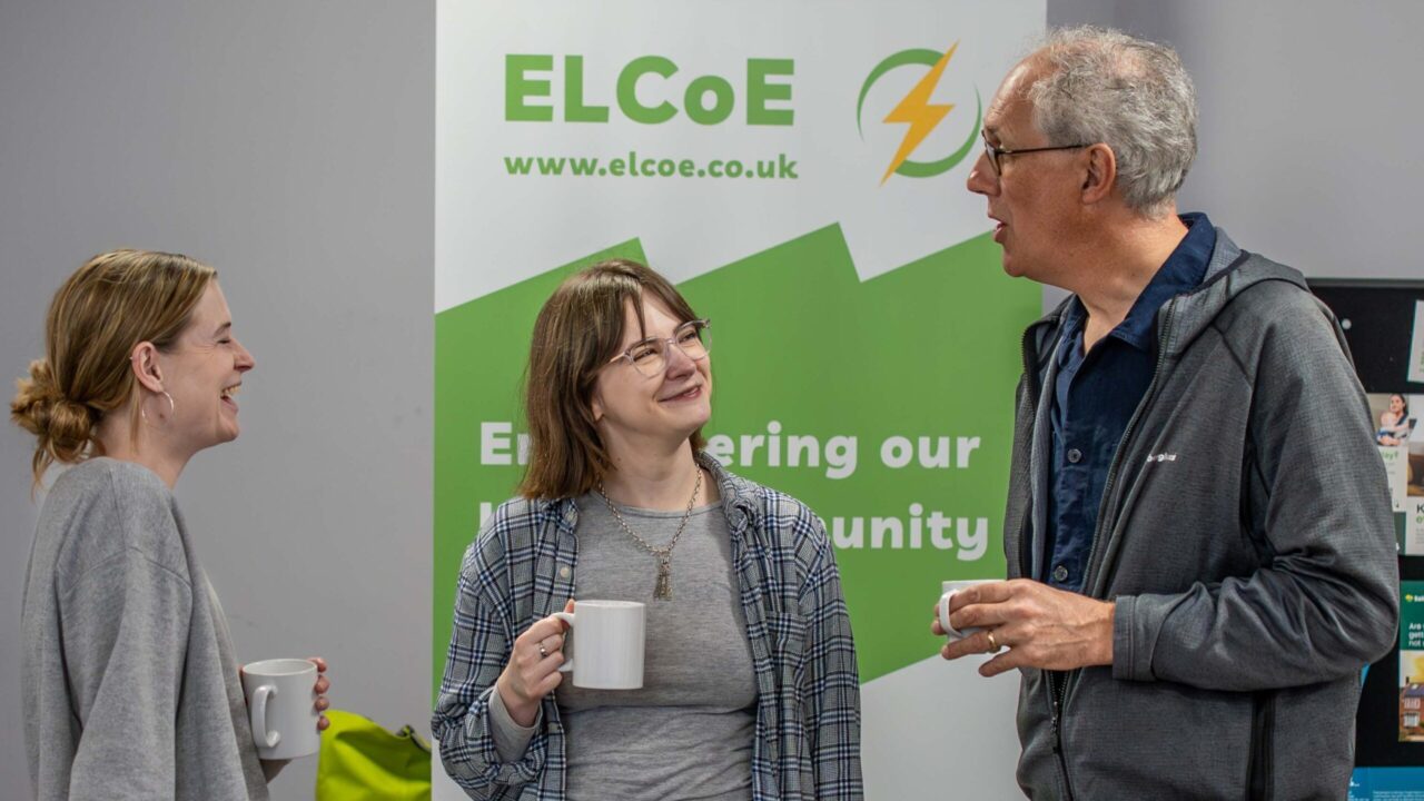 3 people having a conversation at a community event in south gloucestershire